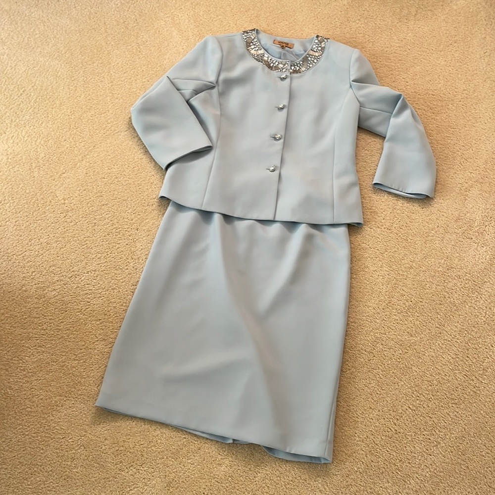 Kasper lt. blue skirt suit w/crystal buttons and collar embellishment. Size 10.